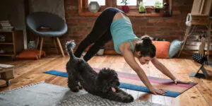 Woman doing yoga with her dog